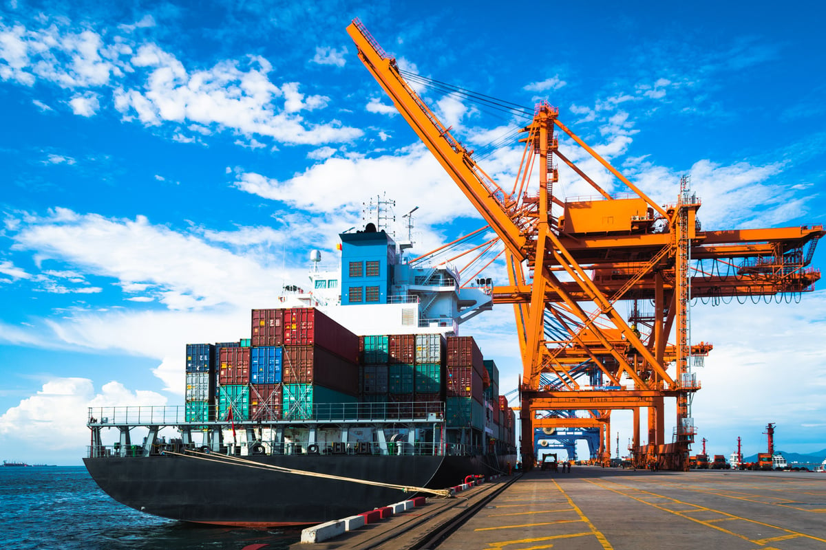 Large container ship discharging and loading container cargo at port terminal. Shipping industry. Logistics and supply chains.